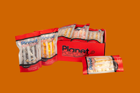 Planet Popcorn packaging on an orange background