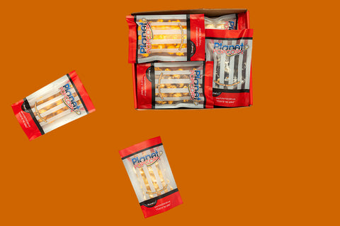 Packaged snacks with red and black branding on an orange background