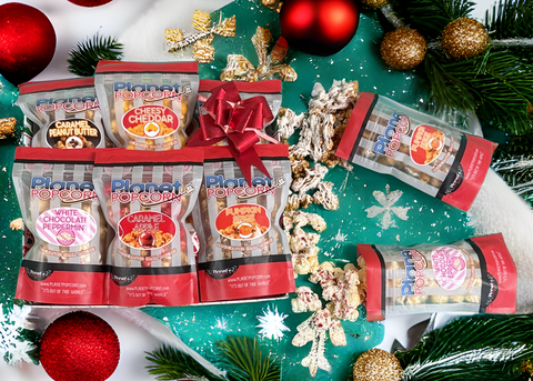 Popcorn packages with Christmas decorations on a green background