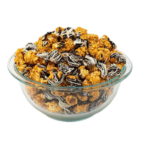 Glass bowl filled with chocolate-covered popcorn on a white background